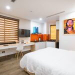 Bright modern hotel room with stylish decor and cozy ambiance.