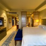 Spacious luxury hotel room with elegant decor and modern amenities located in Mumbai, India.